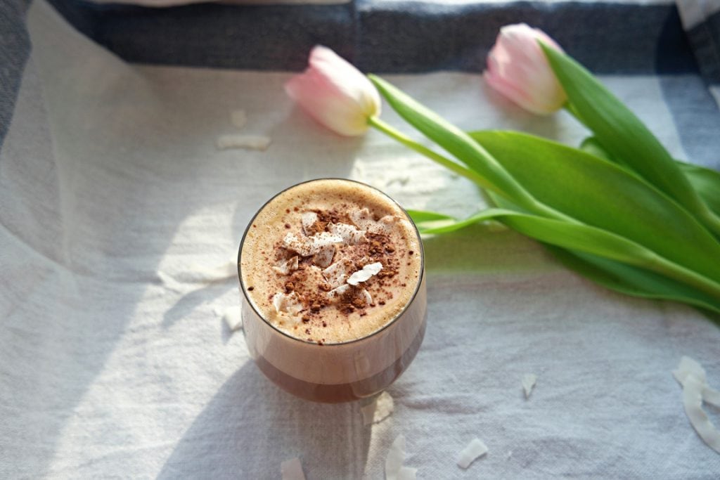 Cacao Coconut Latte next to Tulips