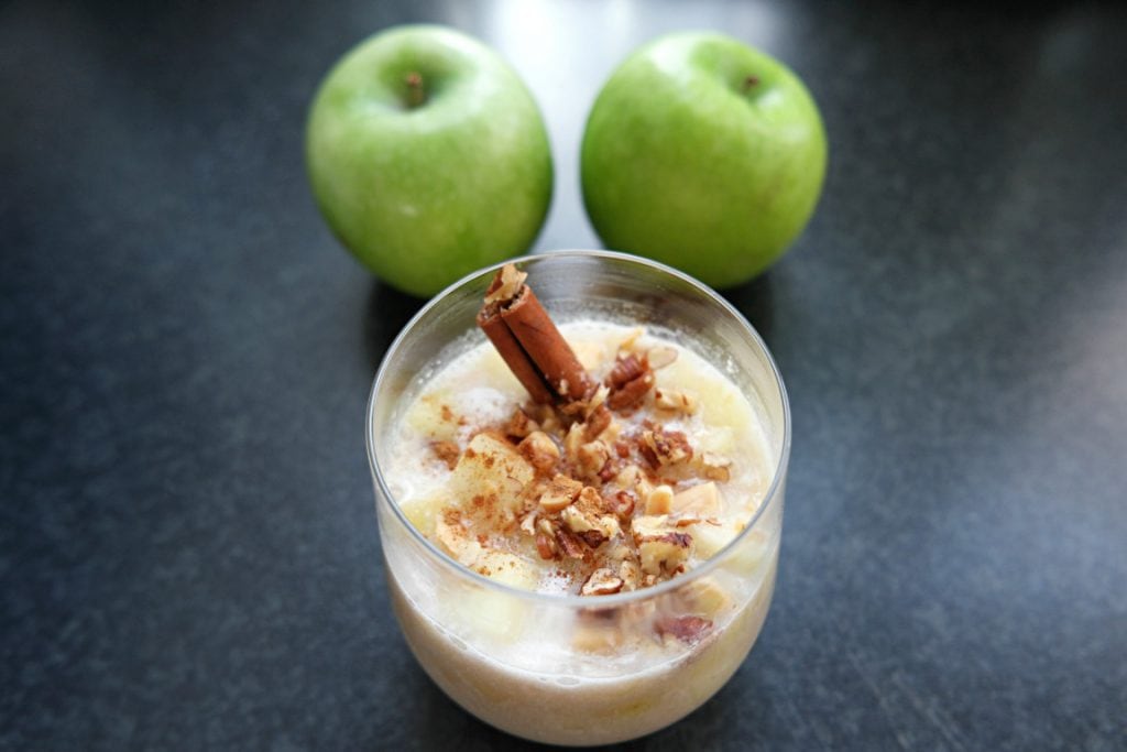 A glass of Apple Oat Milk Drink with Apples